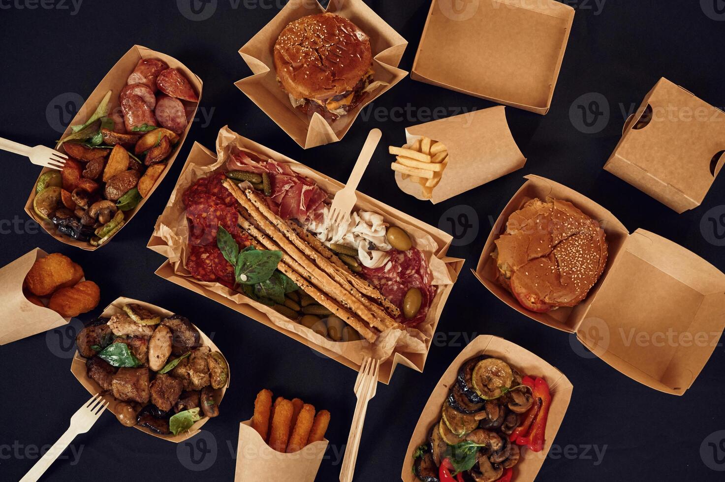 Top view of table with, food on it. Meat, vegetables, French fries, burger, mushrooms photo