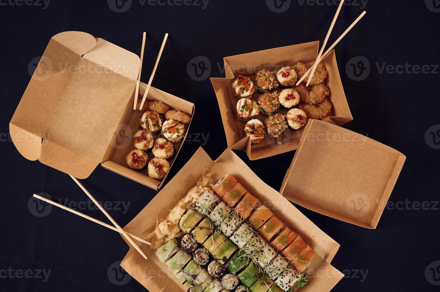 Top view, of sushi rolls that is in the paper eco, boxes on the table photo