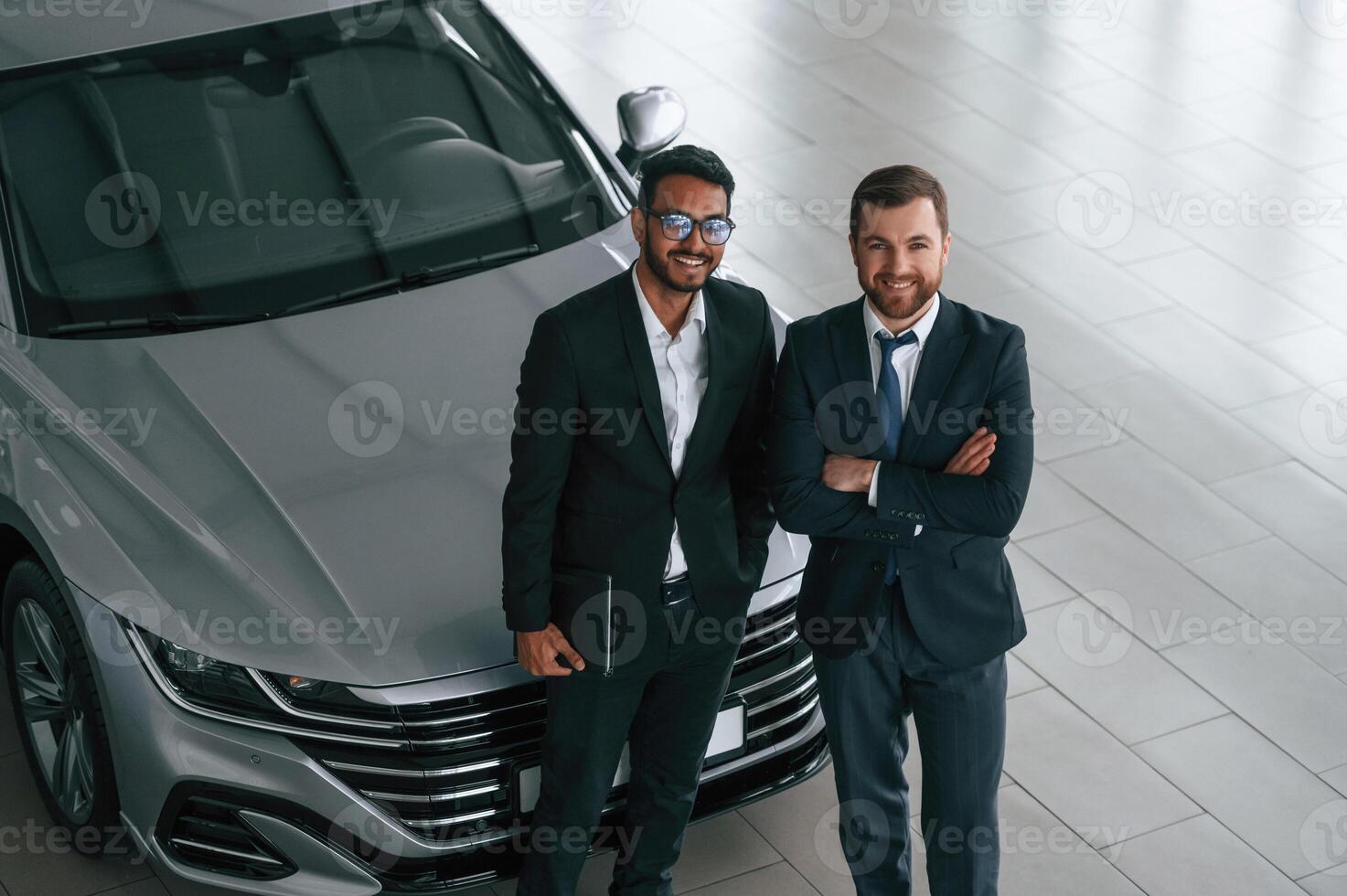View, from the ,top. Two businessmen are working together in the car showroom photo