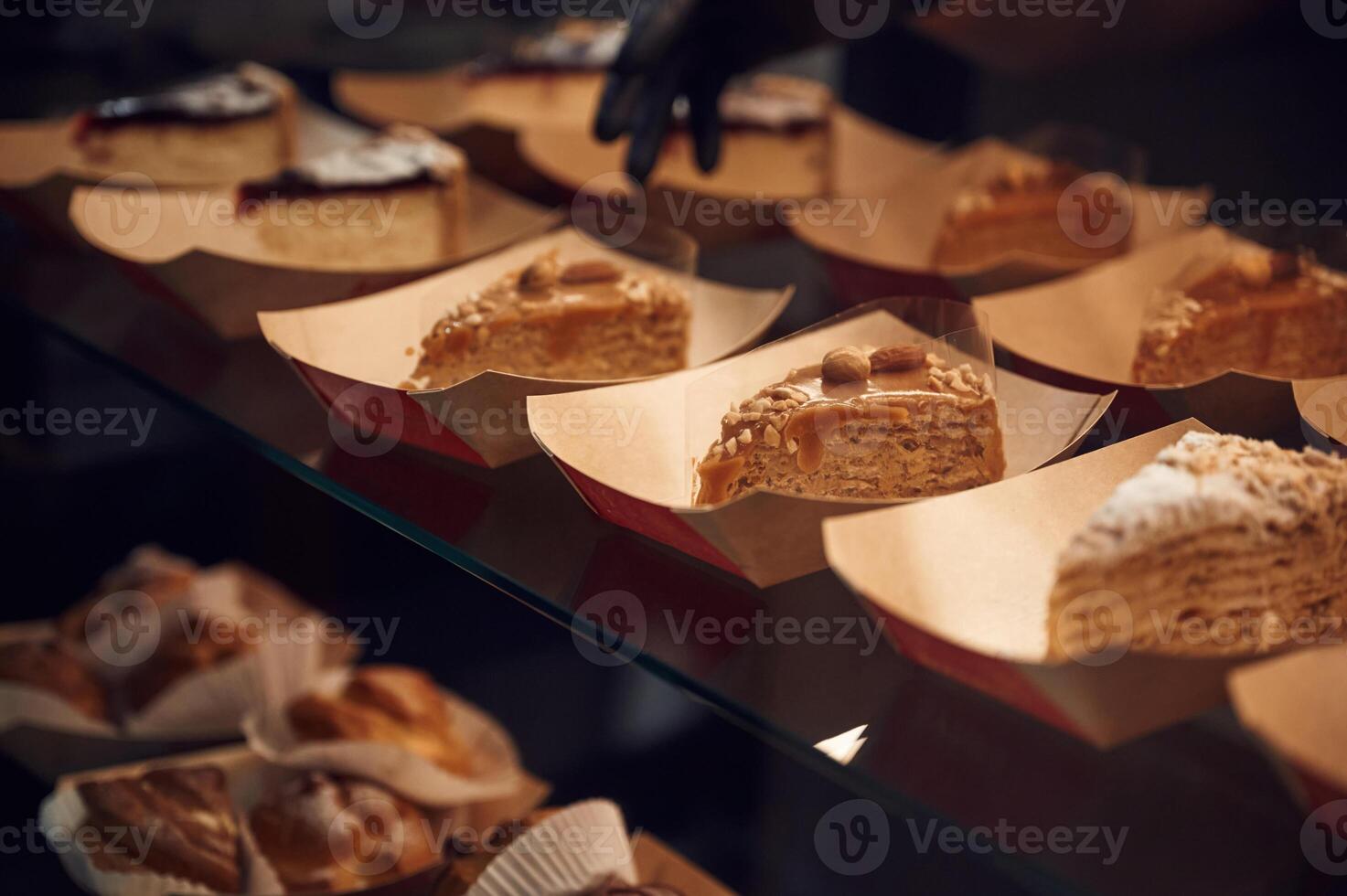Close ,up view of man's hands in gloves that taking delicious desserts photo