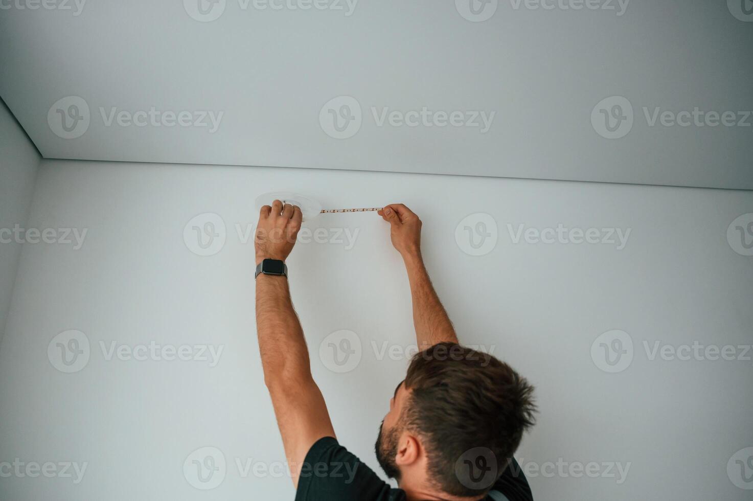 Man is working with lighting equipment, indoors at domestic room photo