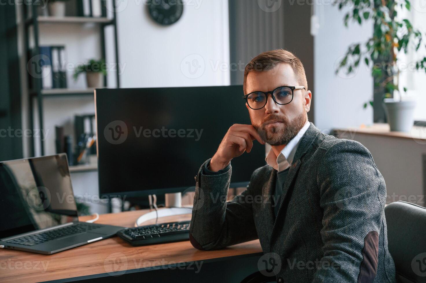 Businessman ,in suit is in the office with computer. photo