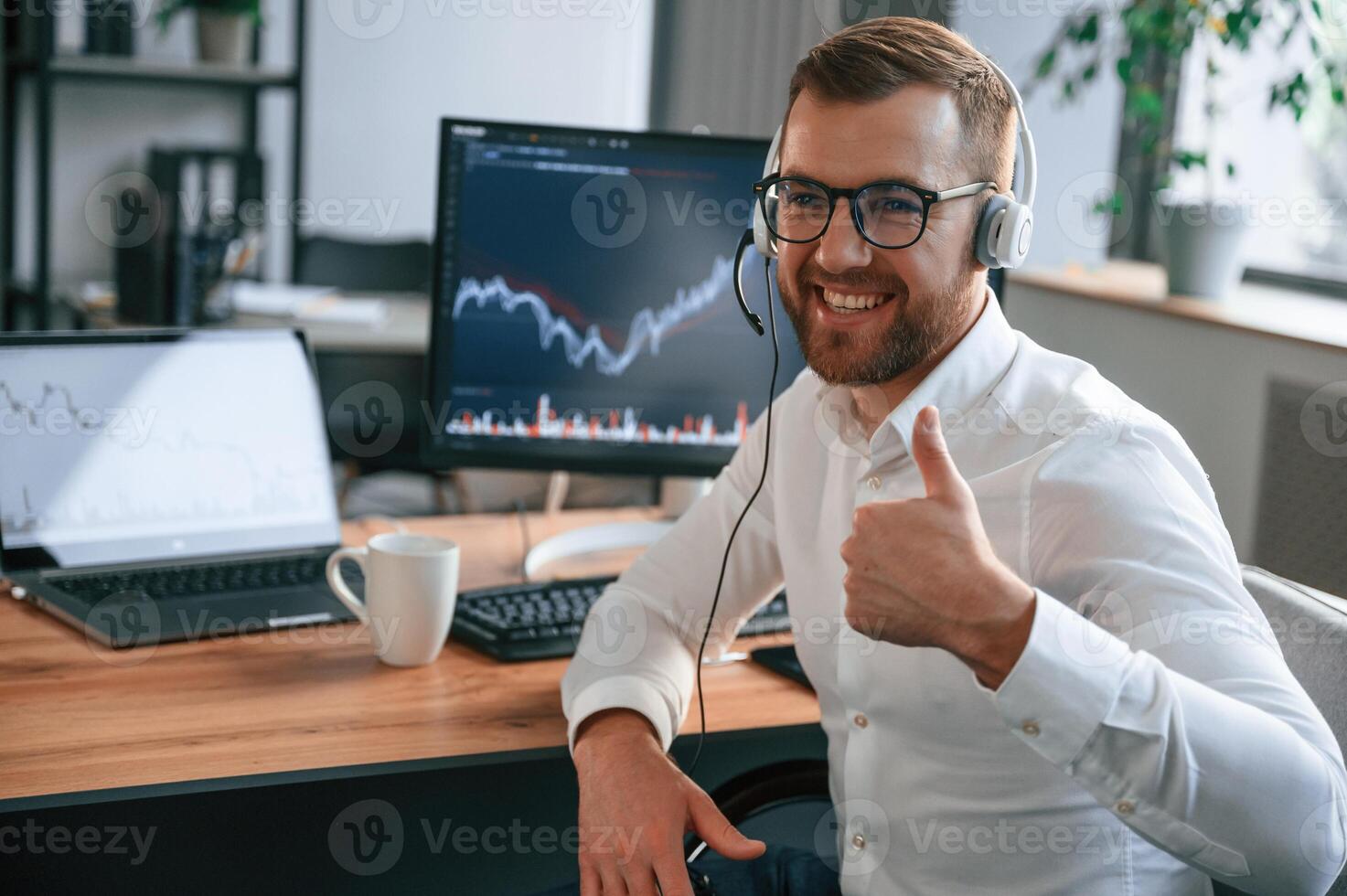 Stock ,exchange graphs,on the screen. Man in formal clothes is working in the modern office. Using computer photo