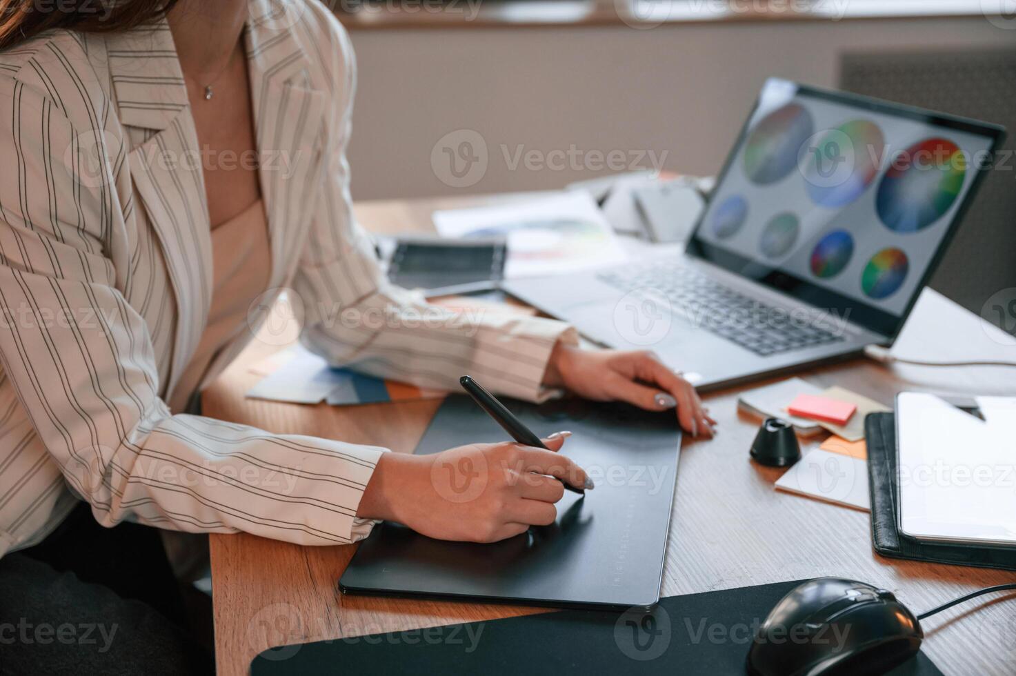 Drawing by ,using graphic tablet. Woman is working in the modern office with computer photo