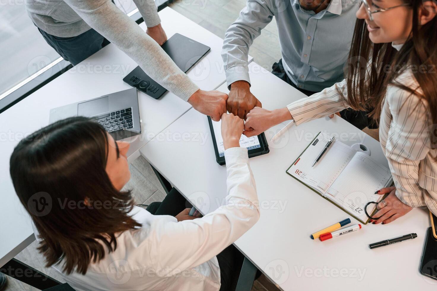 Top ,view. .Four people are working in the office together photo