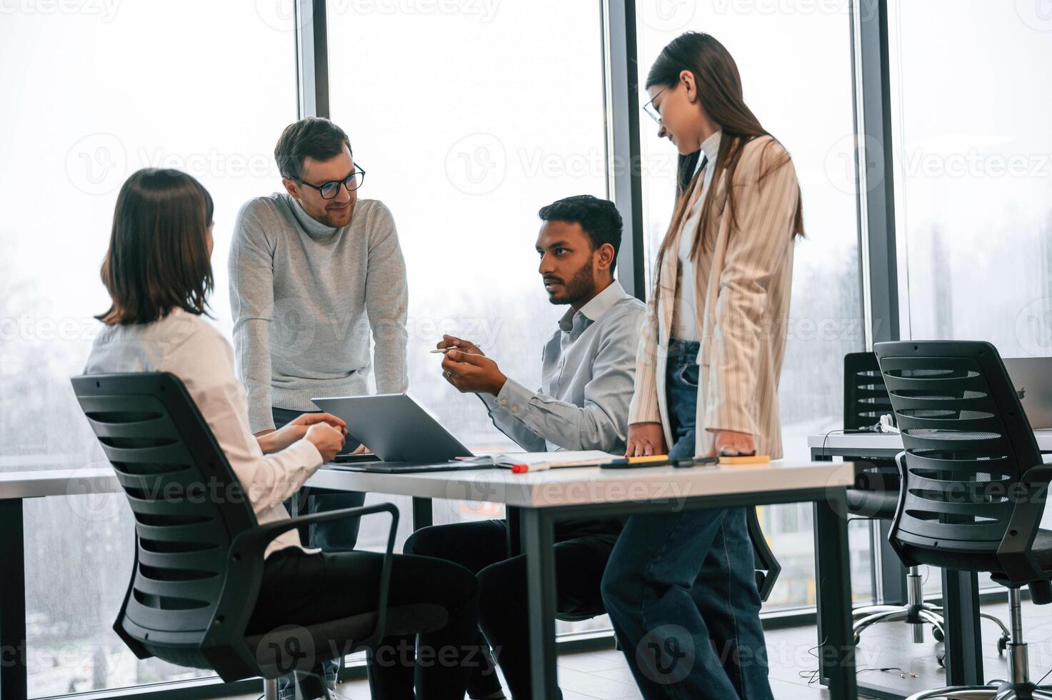 Conception of, brainstorming. Four people are working in the office together photo
