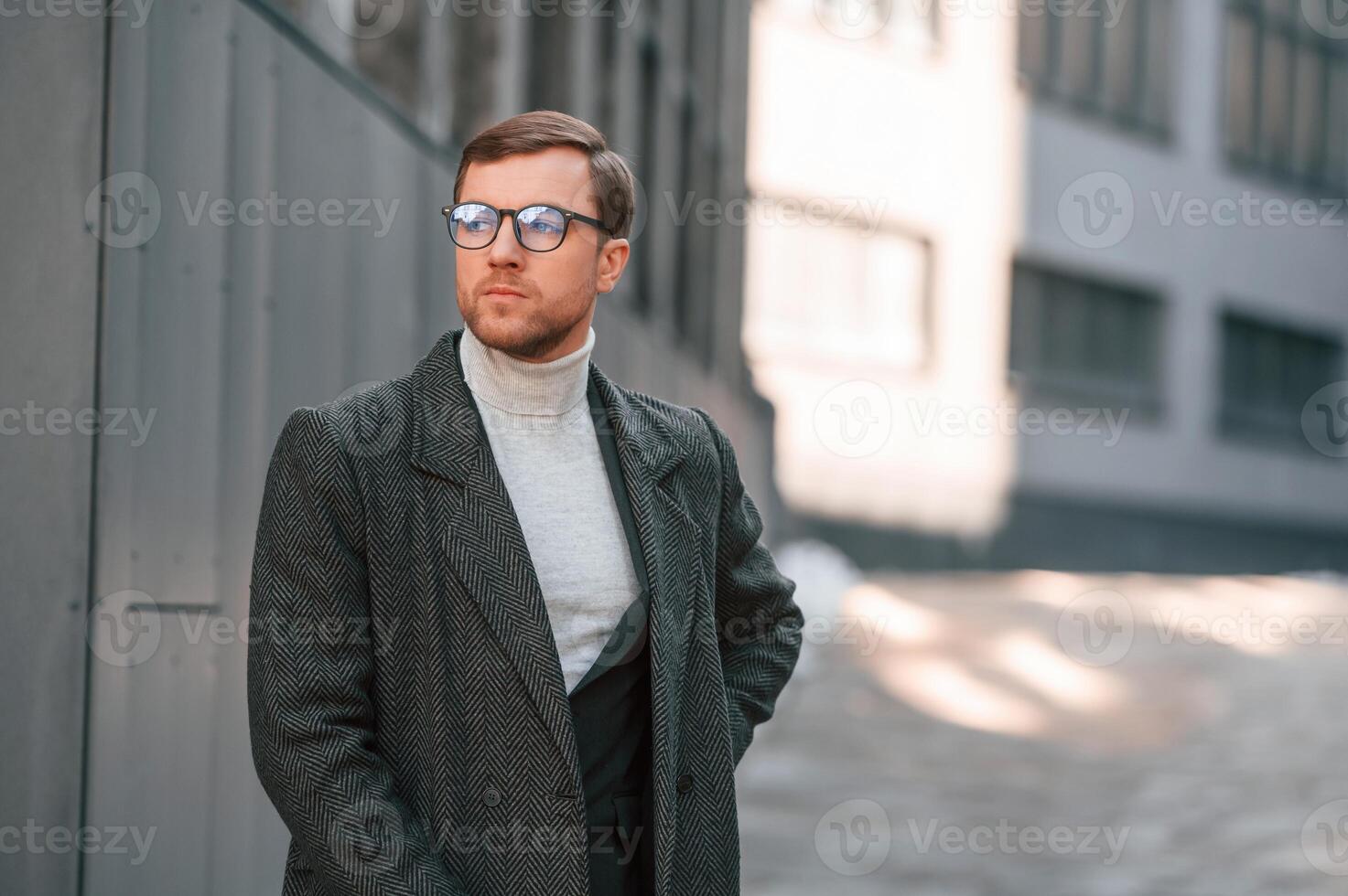 Portrait, of handsome man that is in formal clothes is outdoor near the business building photo
