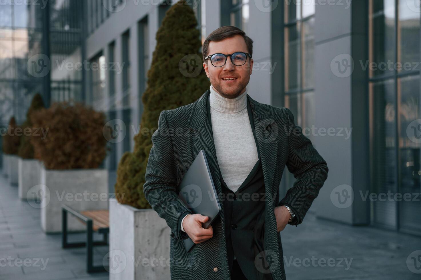 Handsome man, in ,formal clothes is outdoor near the business building photo