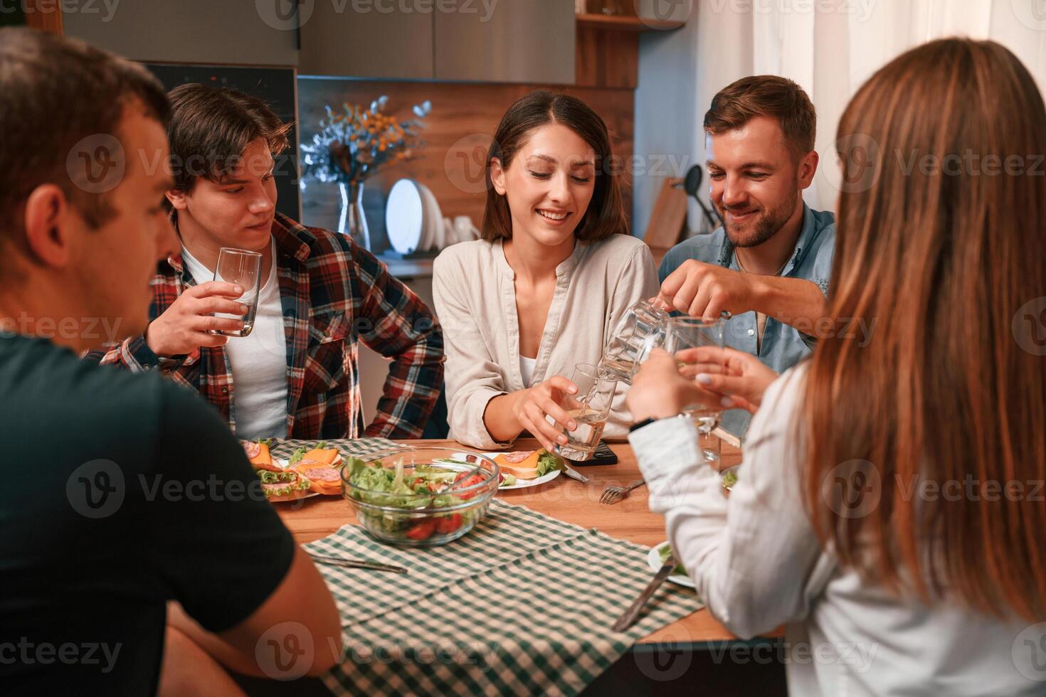 Group, of people are on the kitchen, having dinner, spending time together photo