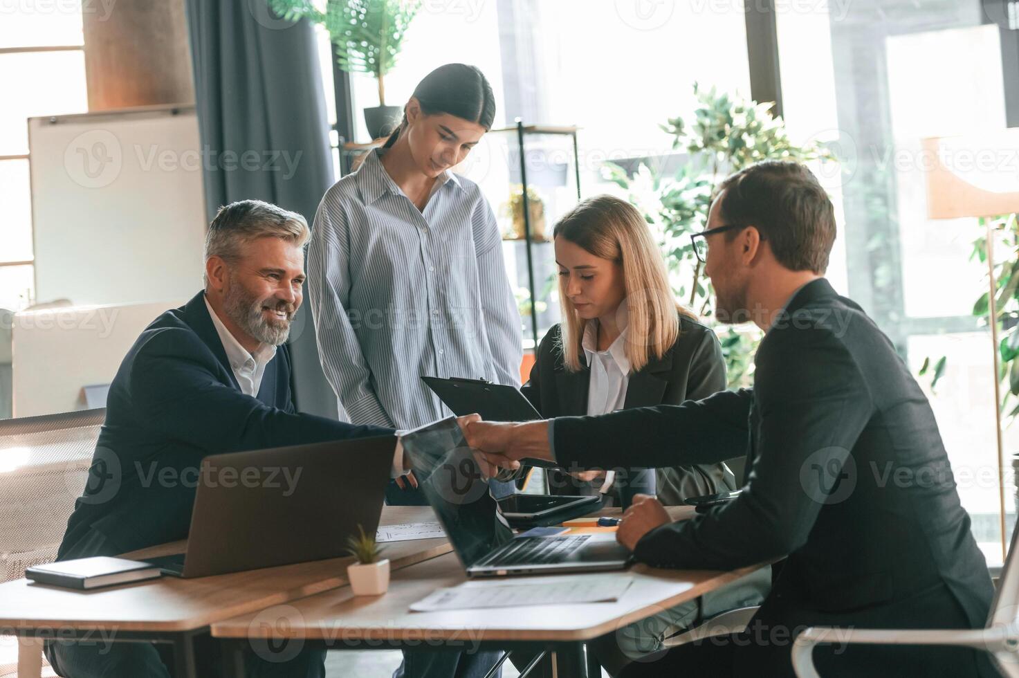 Having ,conversation, talking, about plan. Group of business people are working in the modern office photo