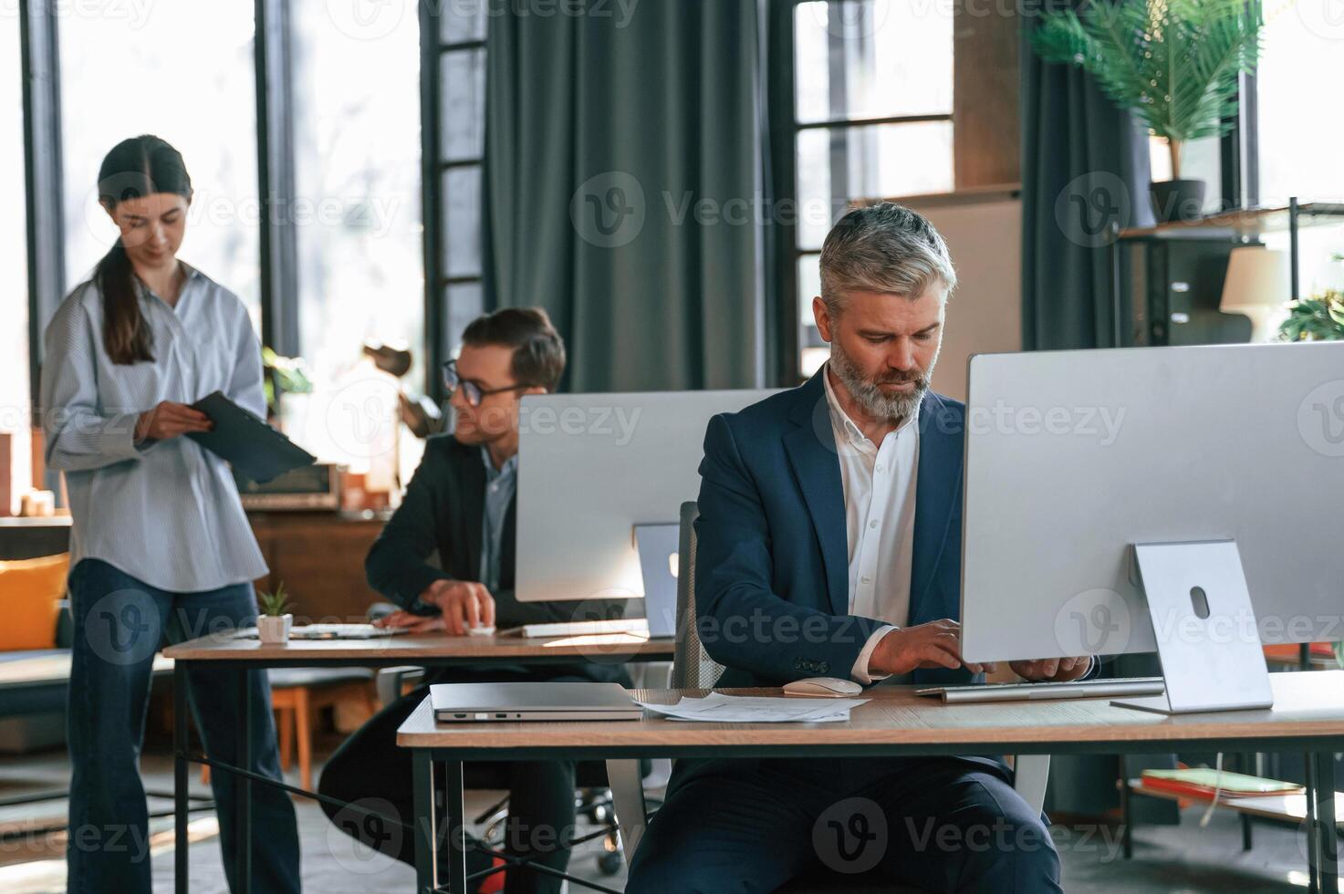 Using ,computer. Group, of business people are working in the modern office photo
