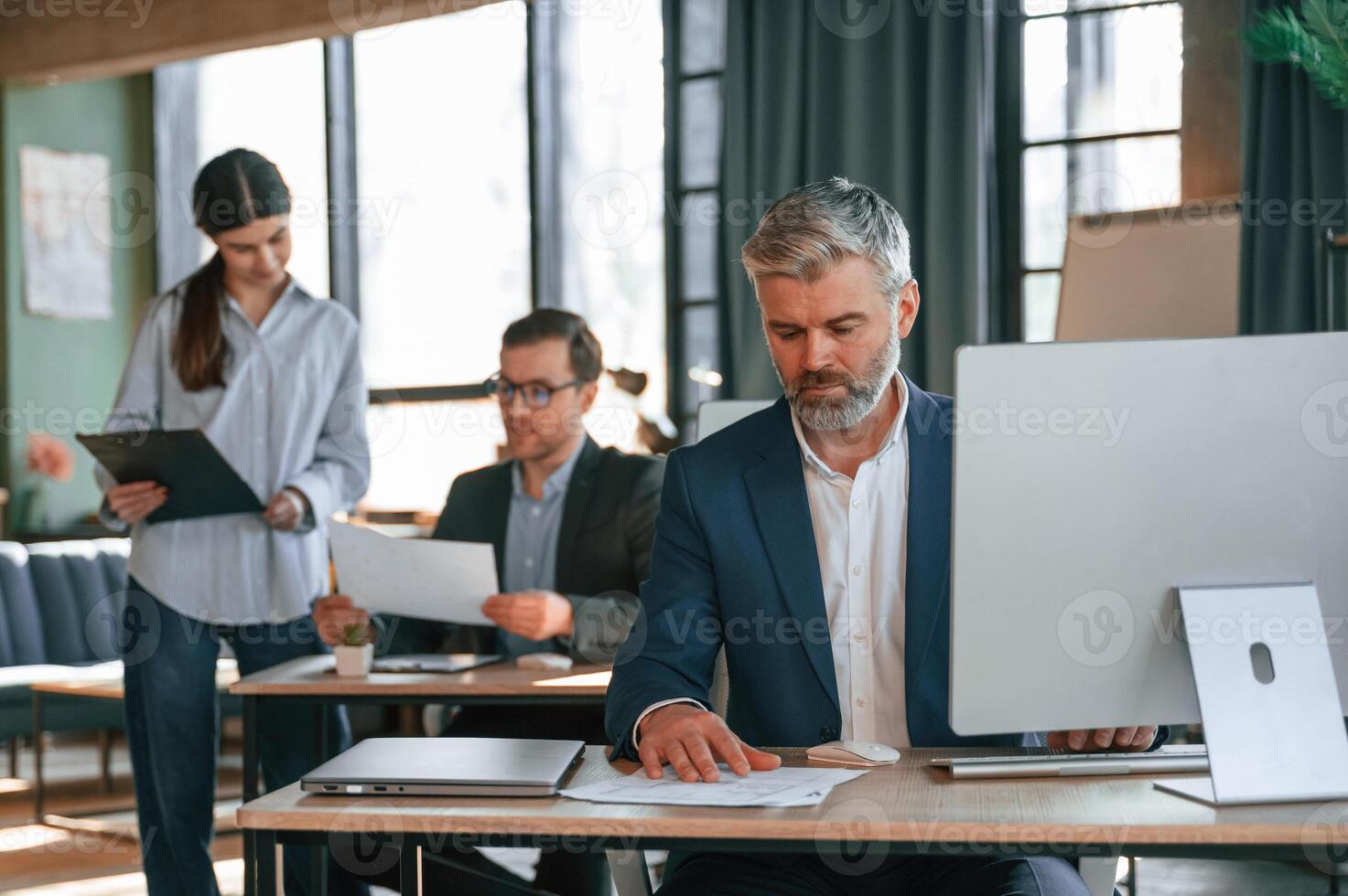 Using computer. Group, of business people are working in the modern office photo
