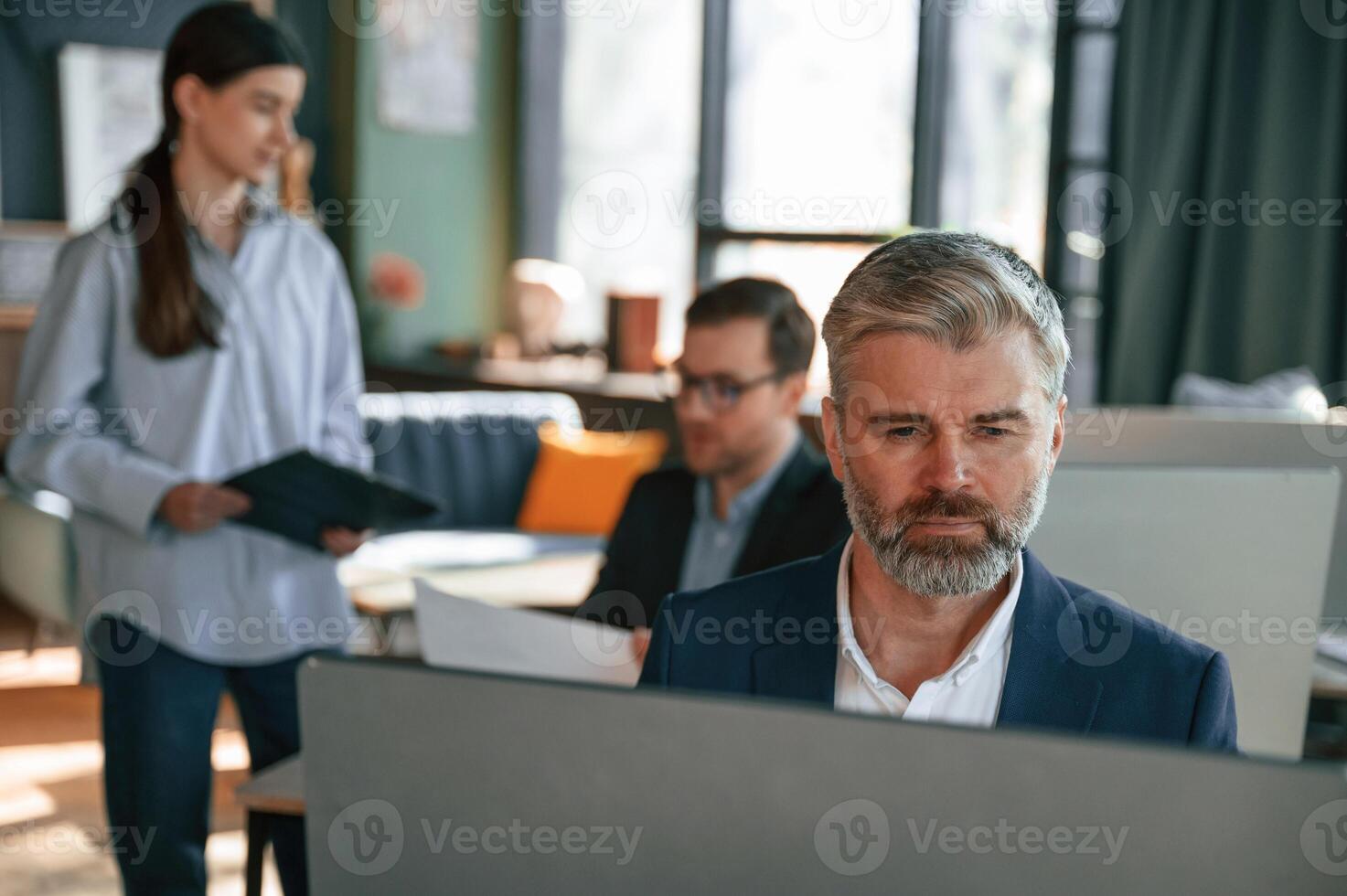 Using ,computer.. Group of business people are working in the modern office photo