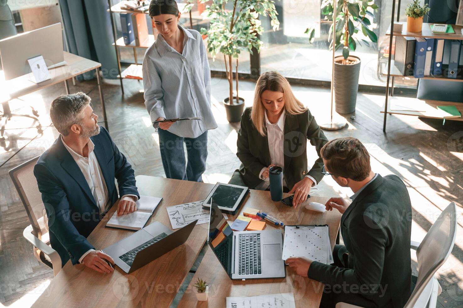 By the table with laptops. Top view. Group of, business people are working in the modern office photo