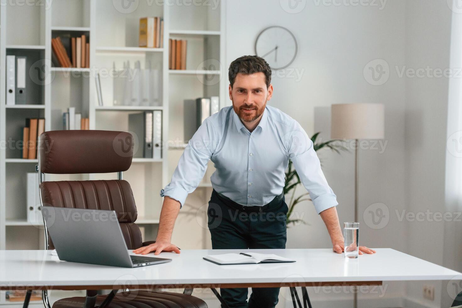 Front view., Doctor in formal clothes is working in the cabinet photo