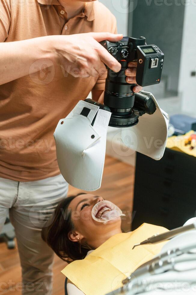 Woman in the stomatology, clinic, visiting dentist, installing the aligner photo