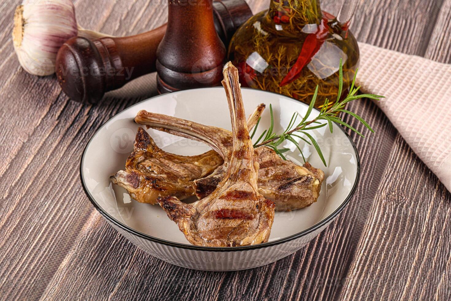 A bowl of meat with a knife and garlic photo