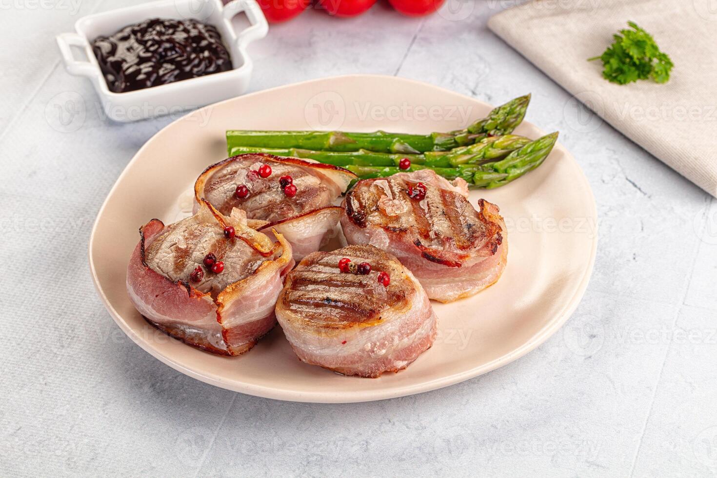A plate of food with asparagus and bacon photo