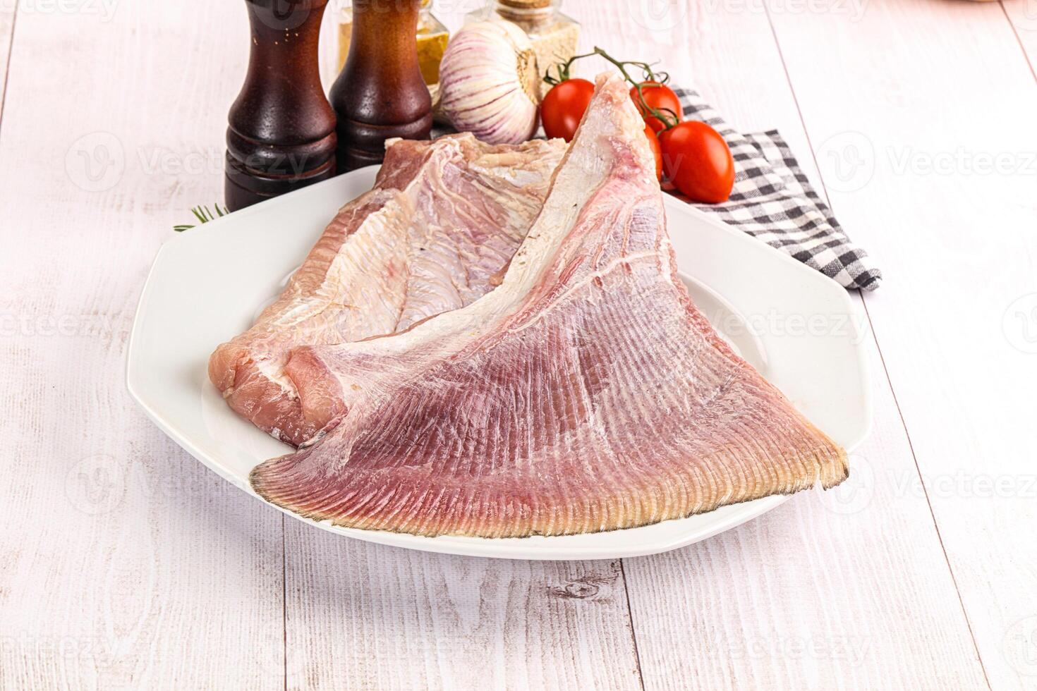 A plate of raw fish on a white table photo