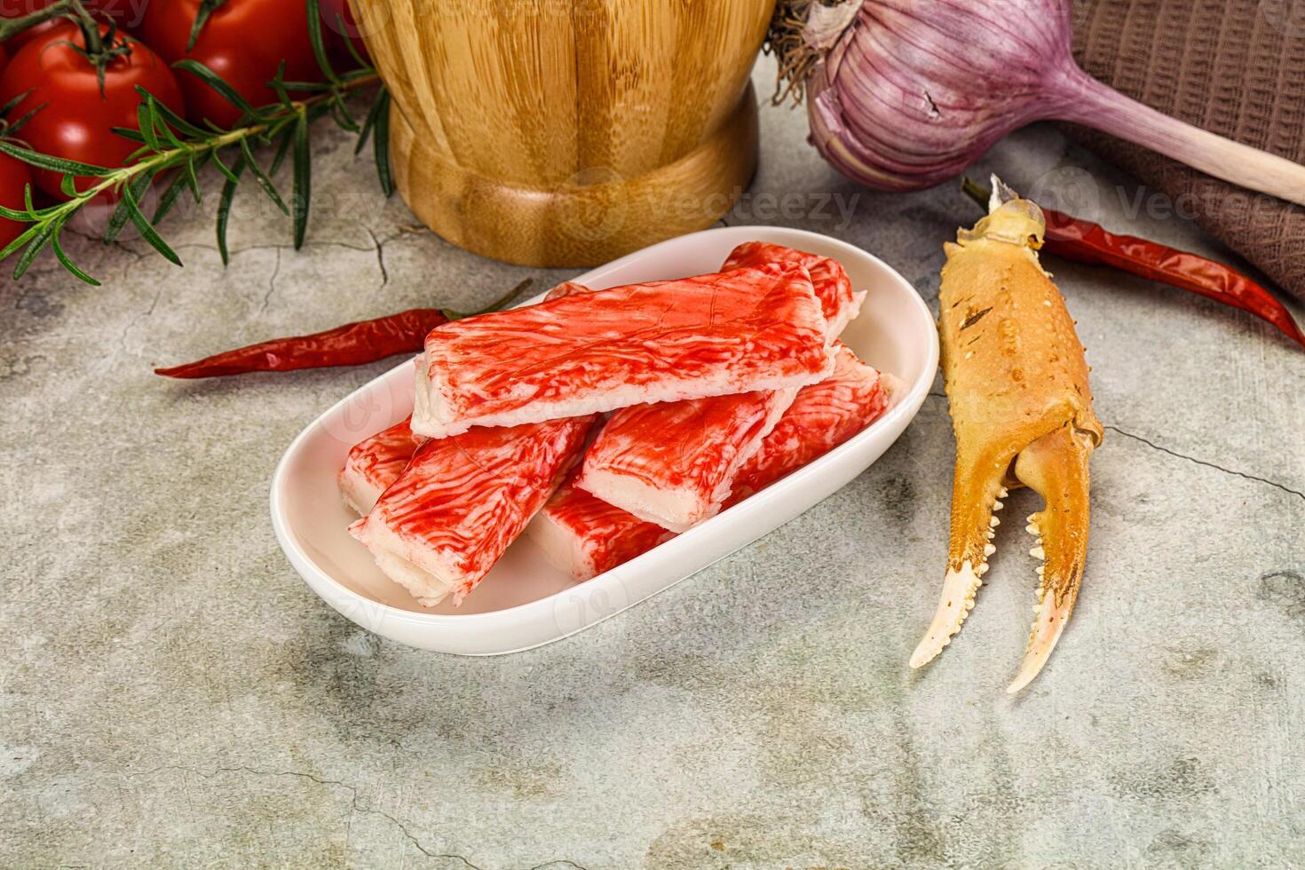 Raw crab meat in a bowl with a knife and garlic photo