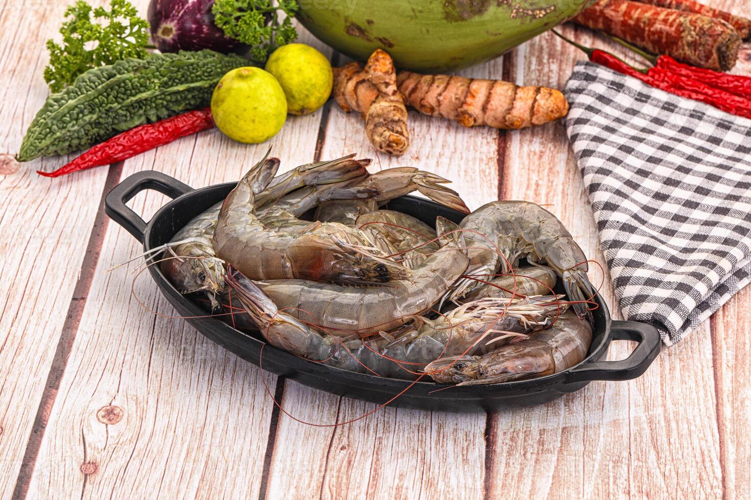 A pan of shrimp on a wooden table photo