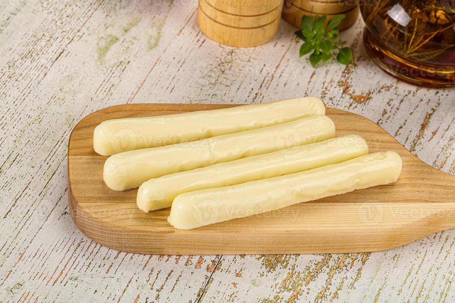 Four pieces of cheese on a wooden cutting board photo