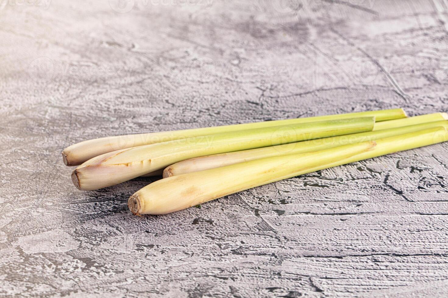 Three fresh green leeks on a gray background photo