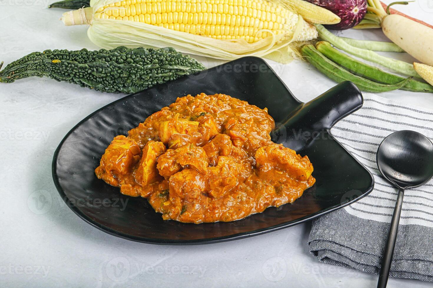 A bowl of food with a spoon and a spoon photo