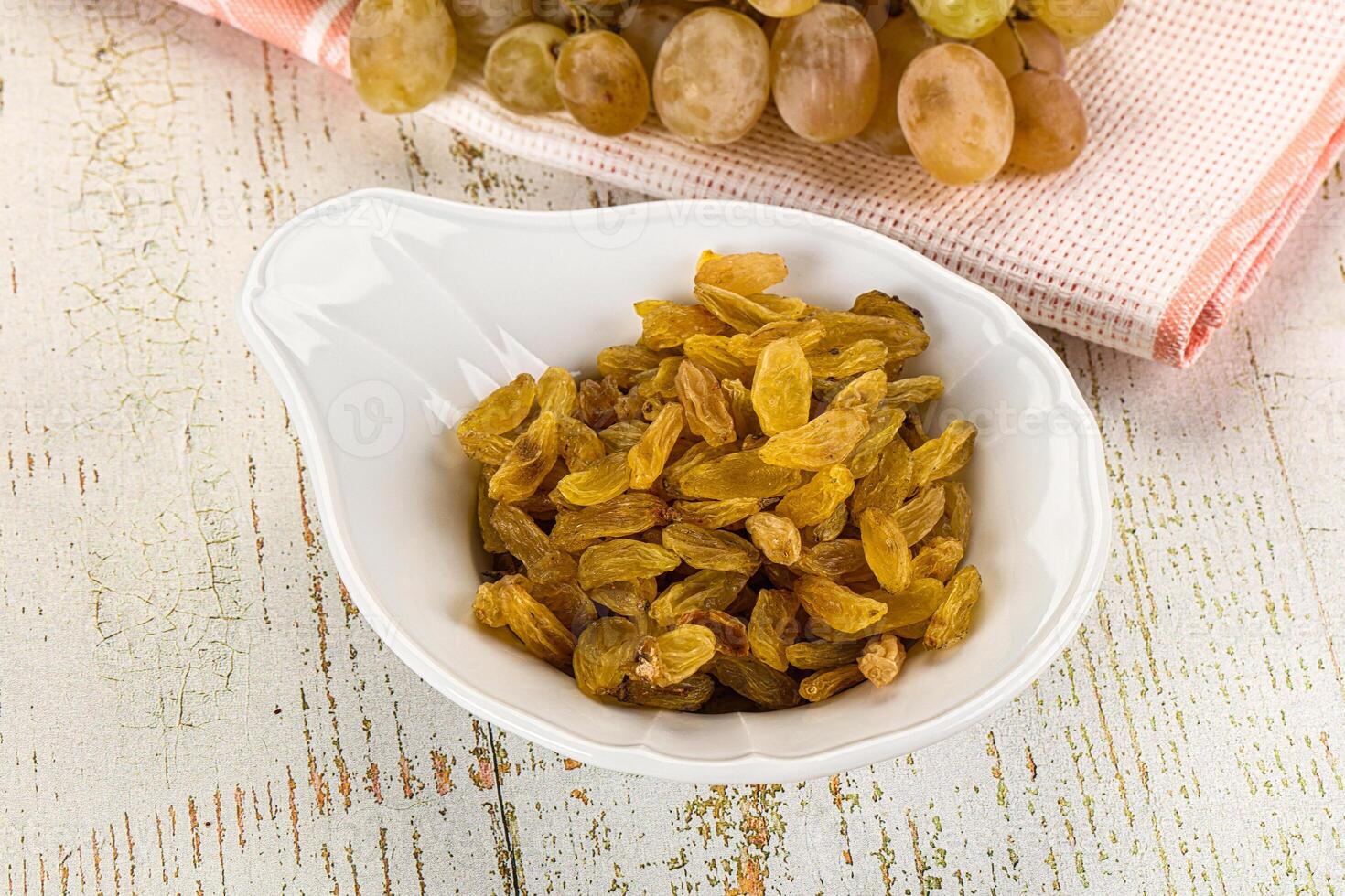 A bowl of raisins sitting on a table photo