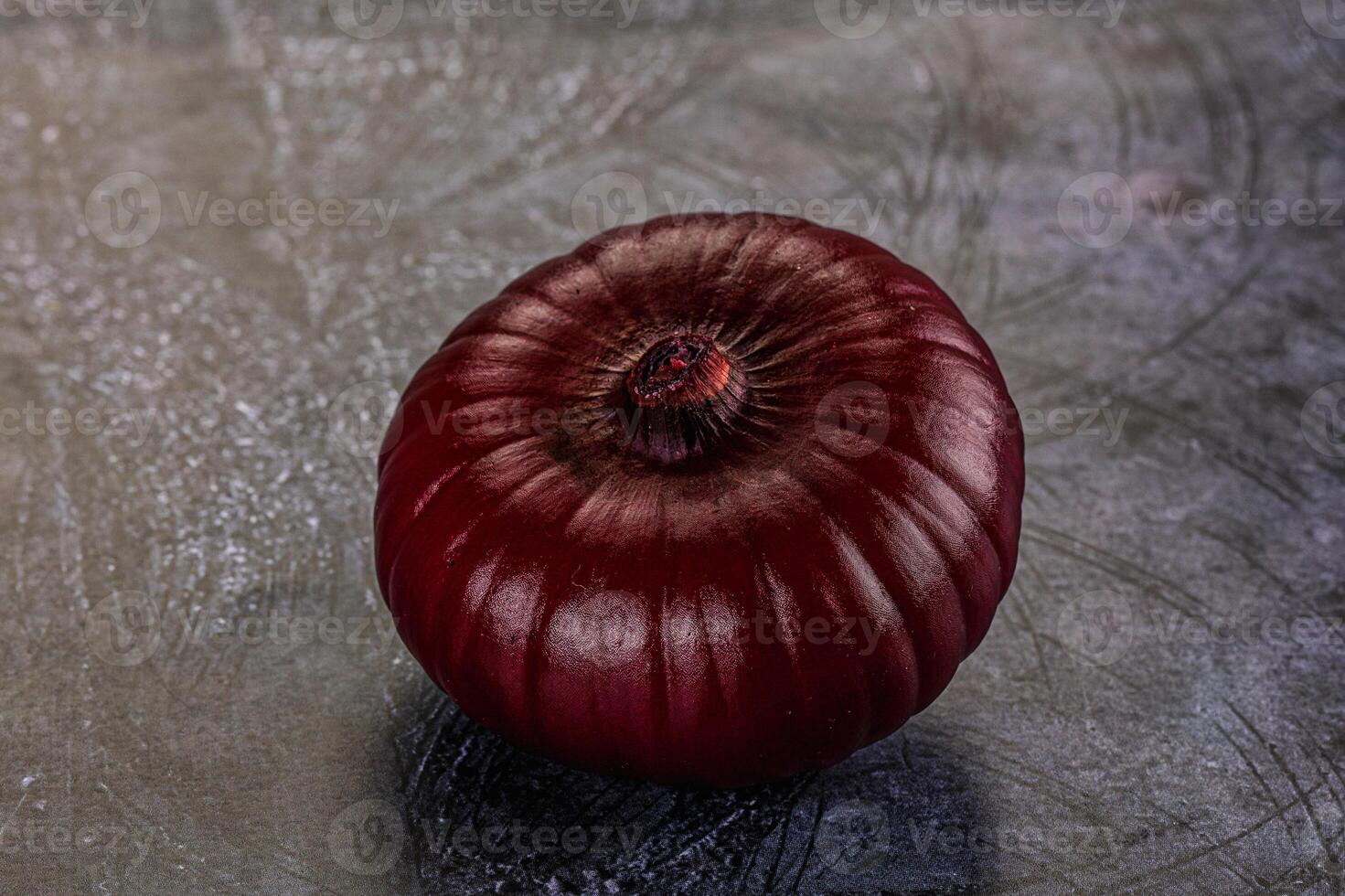 A red onion is sitting on a table photo