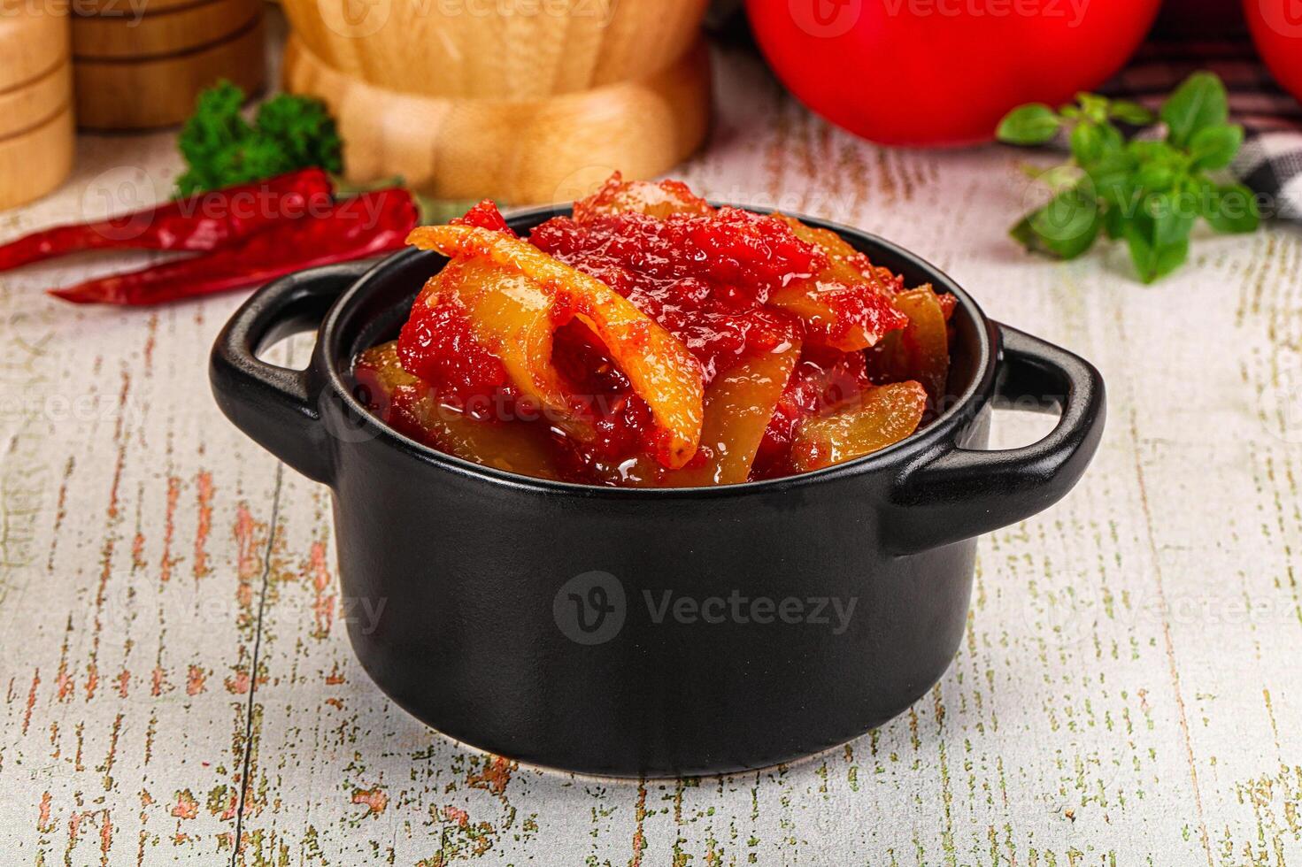 A black cup with a vegetable in it photo