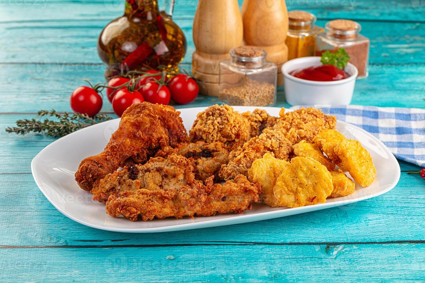 A plate of fried chicken and chips on a table photo