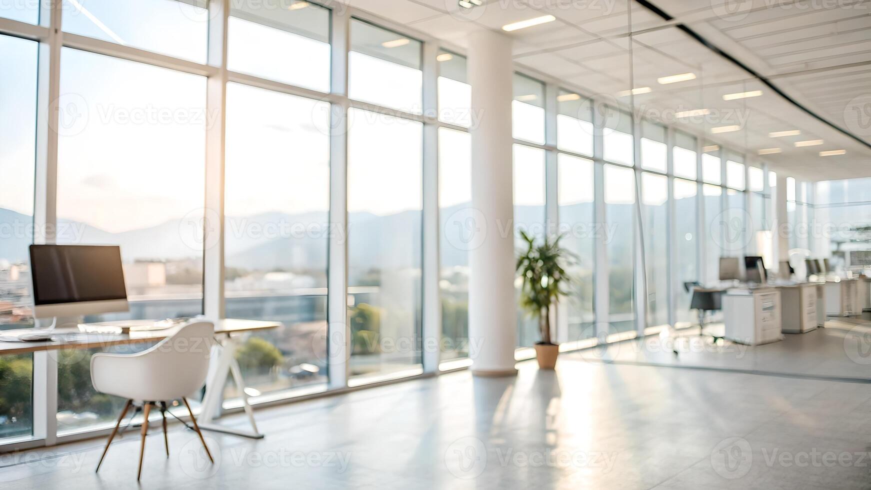 Modern, spacious office with large windows, natural light, and a scenic mountain view, featuring sleek desks, chairs, and minimalistic design. photo