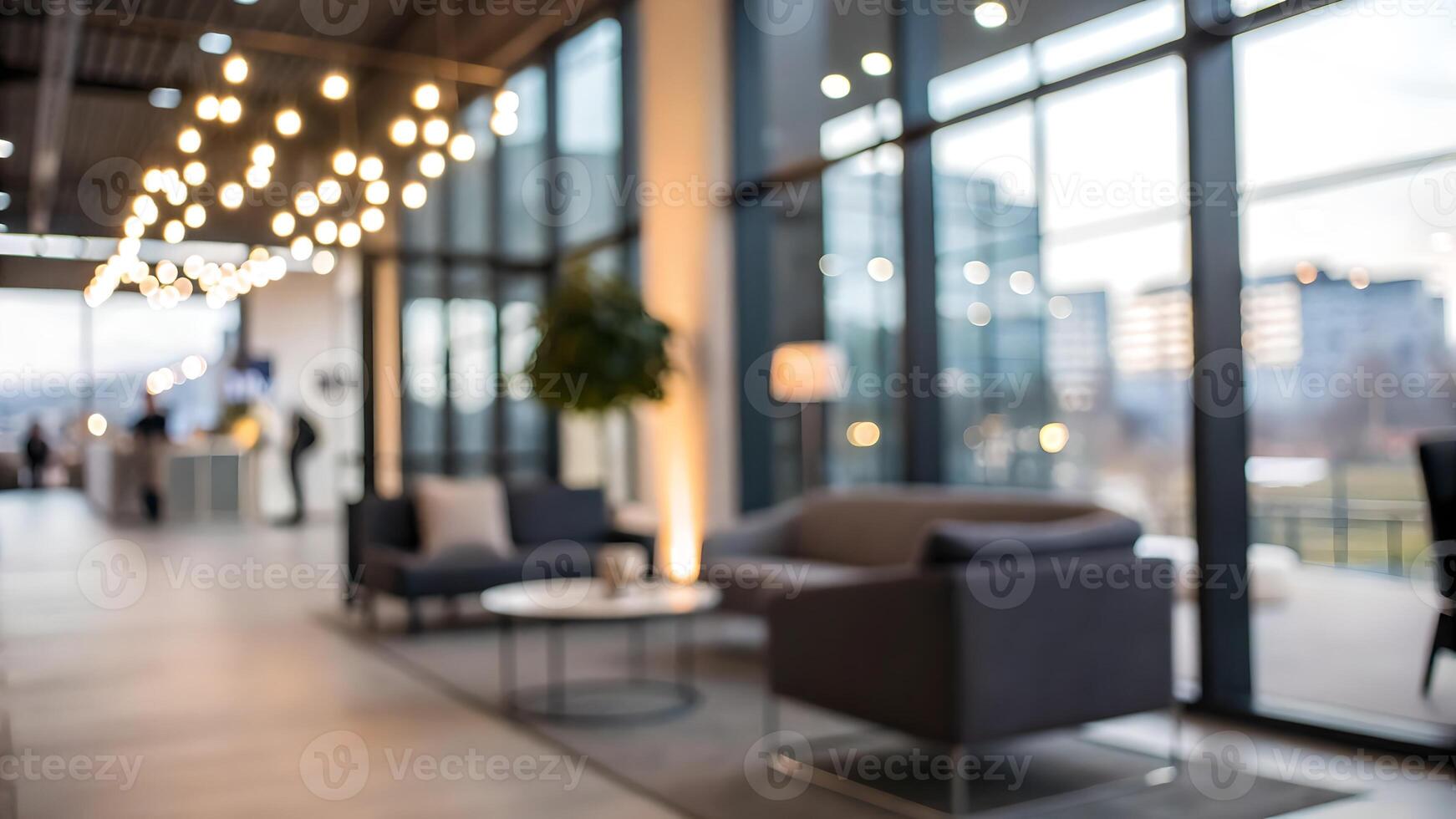 Modern office lounge with cozy seating, large windows, and warm string lights creating a welcoming atmosphere for relaxation and casual meetings. photo