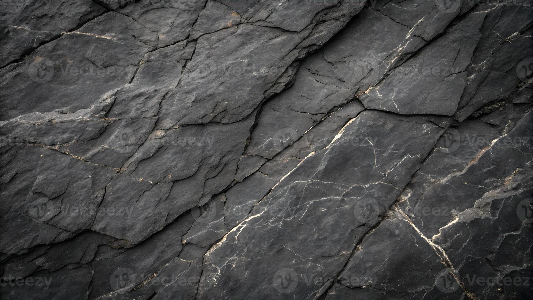 Dark slate rock surface with natural cracks and textures, perfect for backgrounds or design elements requiring a rugged, natural look. photo