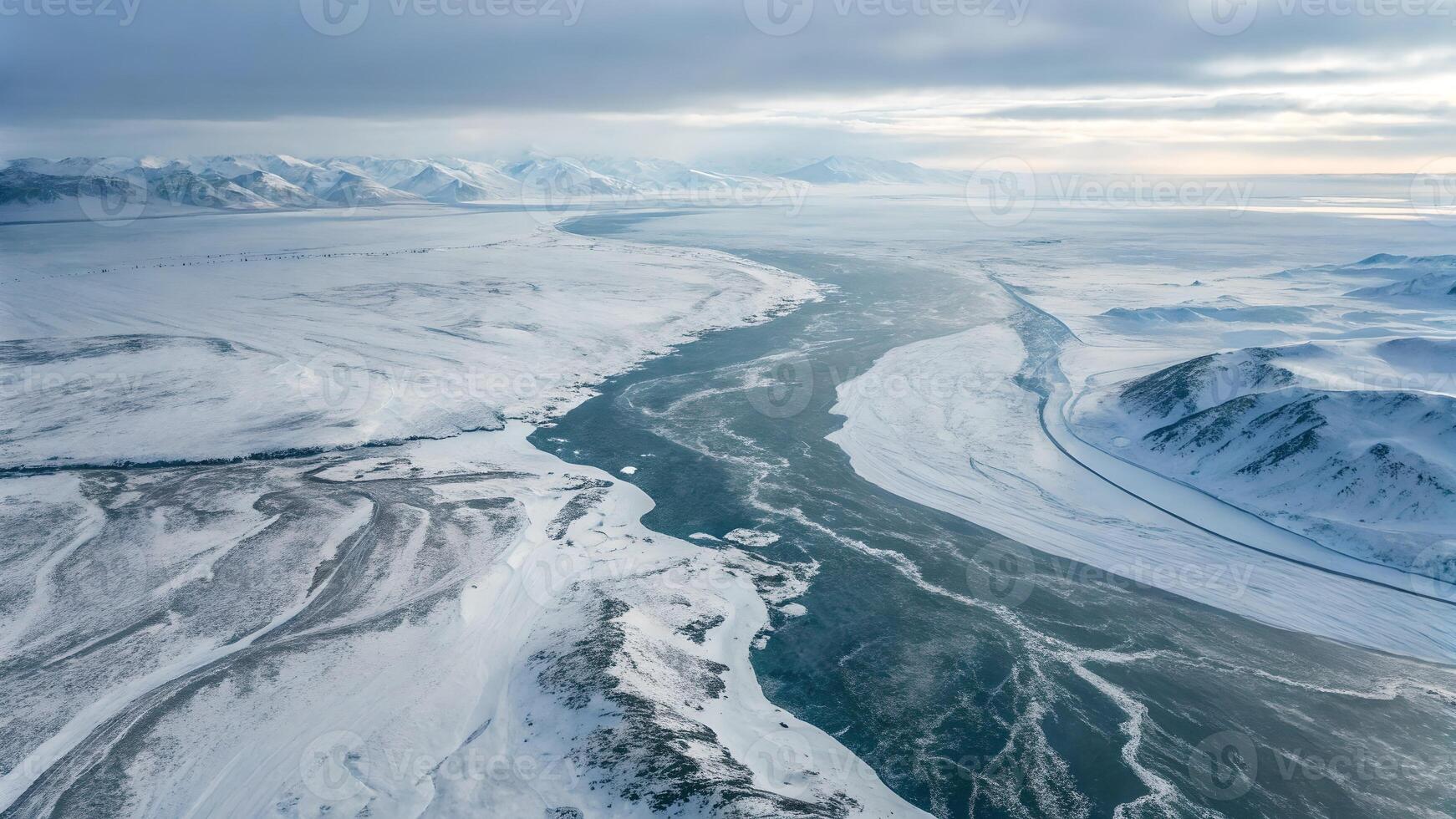 Aerial View of Snowy Landscape with Frozen River and Mountain Range for Nature Enthusiasts snow photo
