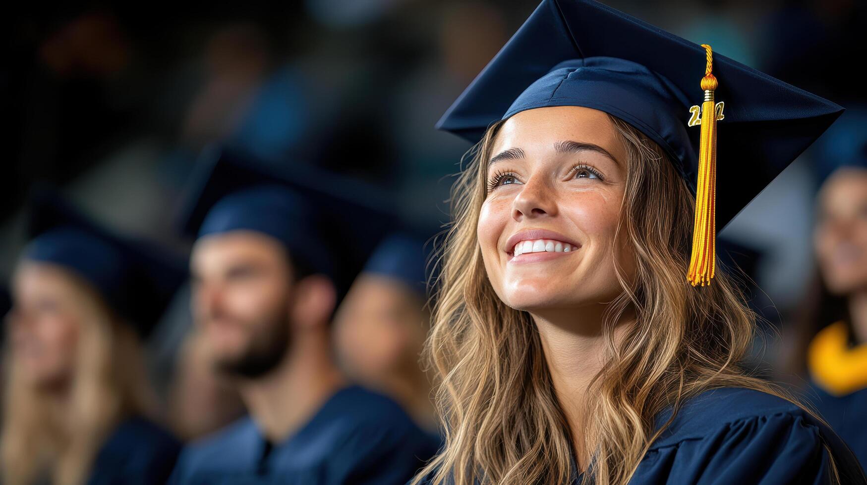 Graduation ceremony with smiling woman in cap and gown, celebrating success photo