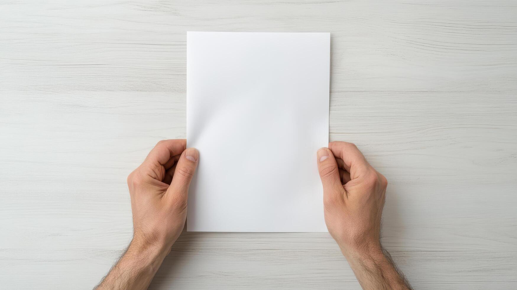 person holding blank sheet of paper with both hands, conveying sense of anticipation or photo
