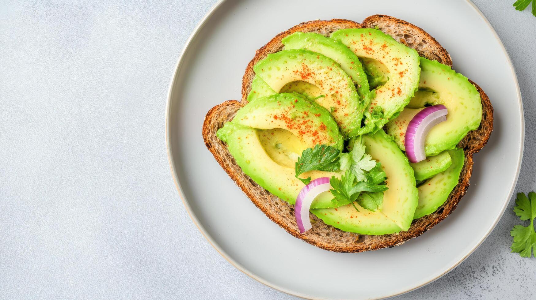 Creamy avocado toast topped with spices and fresh herbs on whole grain bread photo