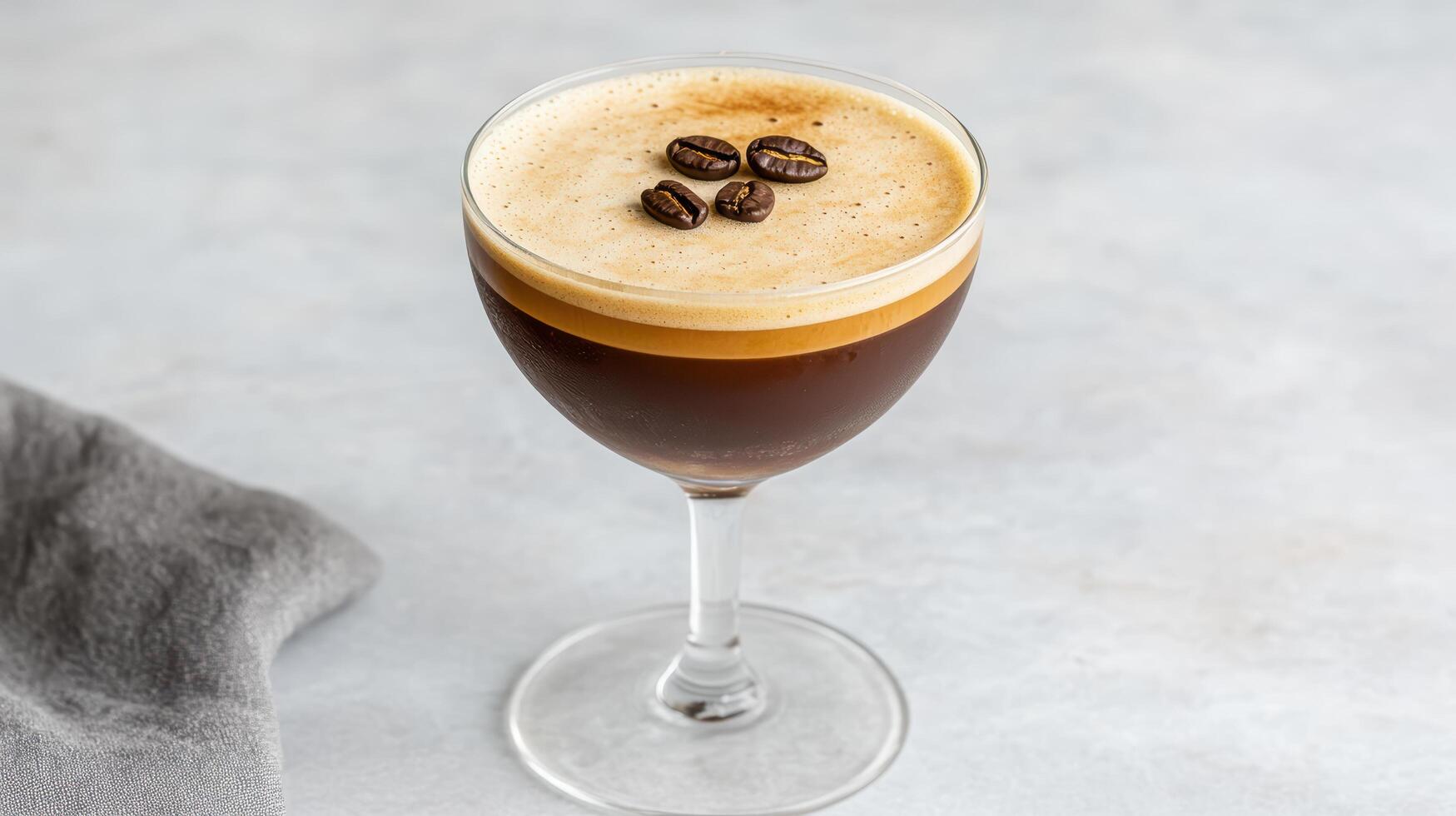 beautifully crafted espresso martini with rich coffee layer and frothy top, garnished with photo