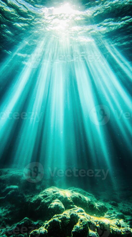 Sunlight beams penetrating clear ocean depth creating ethereal underwater seascape with vibrant aquatic colors photo
