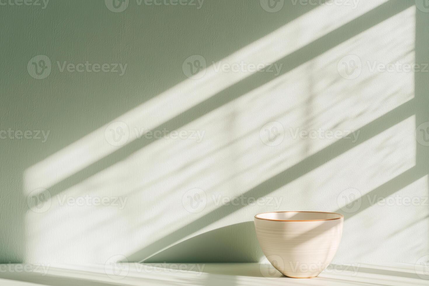 Minimalist ceramic bowl in sunlit room with geometric shadows casting a serene atmosphere photo