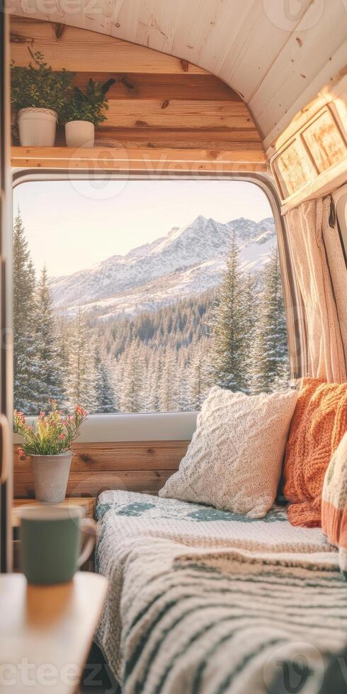 Cozy camper van interior overlooking snow capped mountain landscape at sunrise photo