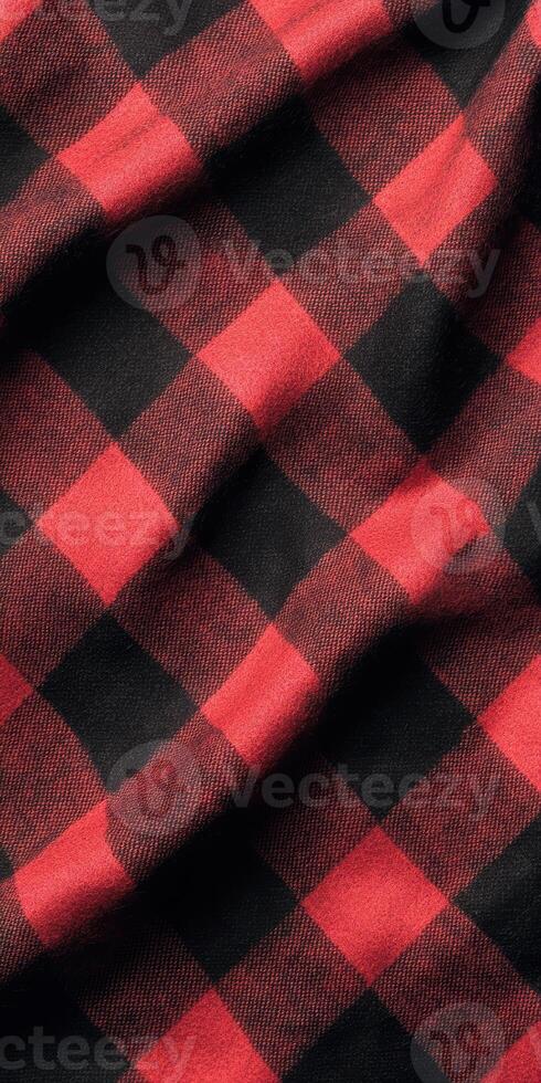 Close up of red and black plaid fabric with soft folds creating a textured pattern photo