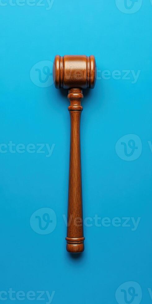 Wooden gavel on blue background symbolizing justice judge decision legal authority concept photo