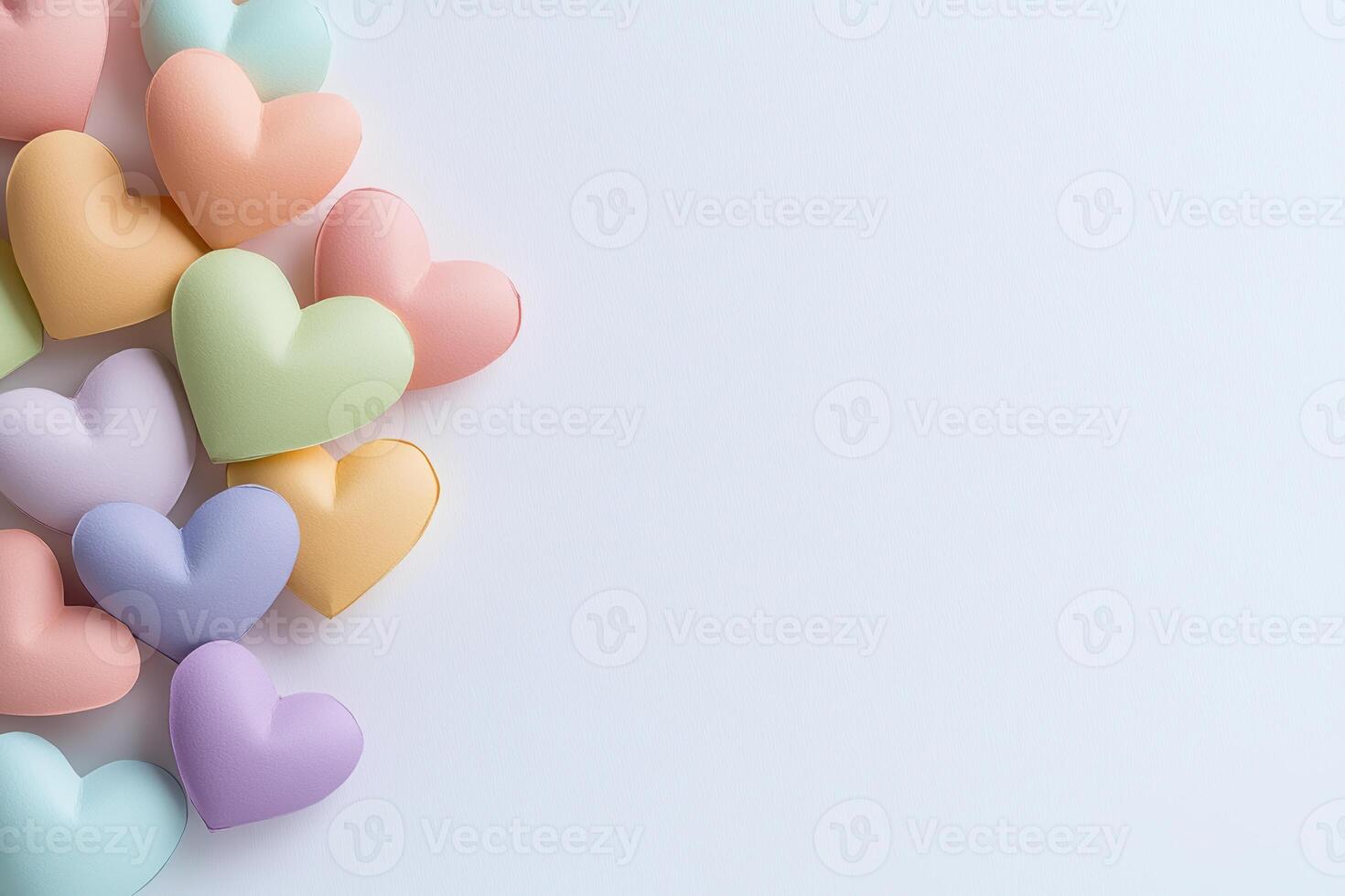 Colorful heart shaped pastel candies arranged on white background with copy space for creative design photo