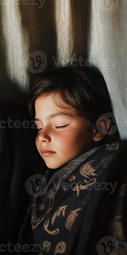 Peaceful child sleeping wrapped in patterned blanket under gentle light, highlighting serene innocence and delicate features photo