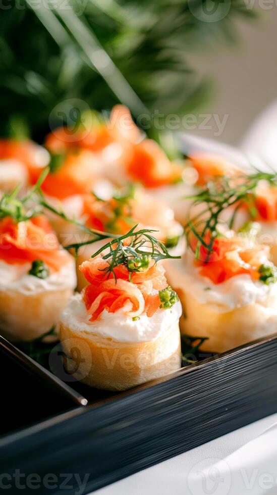 Gourmet smoked salmon canapes with cream cheese and dill garnish on a serving tray in elegant culinary presentation, photo