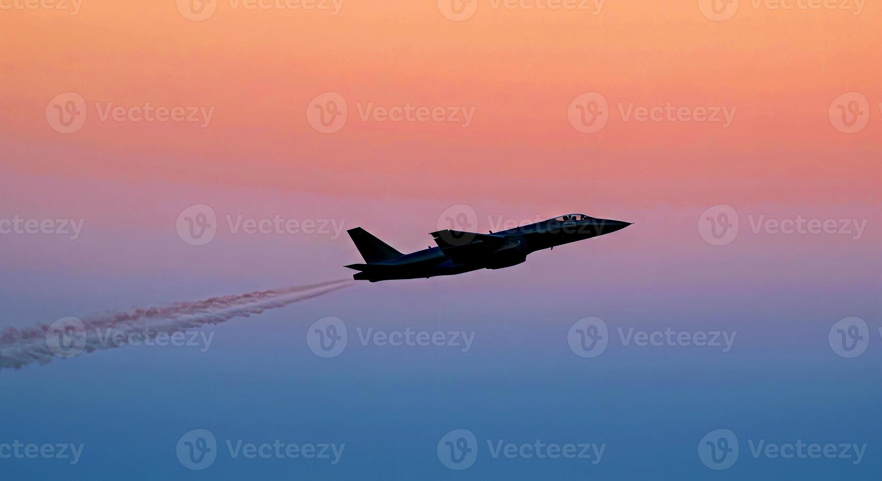 A fighter jet flying in the sky with smoke coming out of it photo