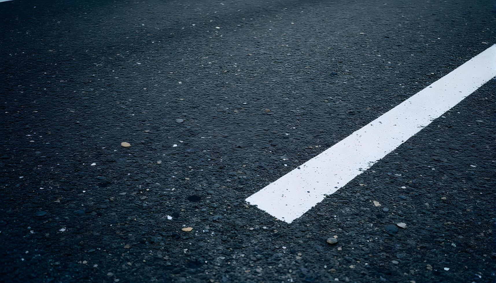 Close-up of asphalt road with a white line marking the lane photo